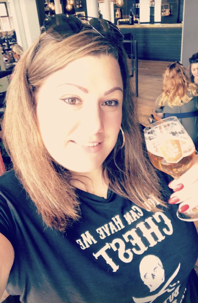 a picture of myself holding a glass of beer in bruge