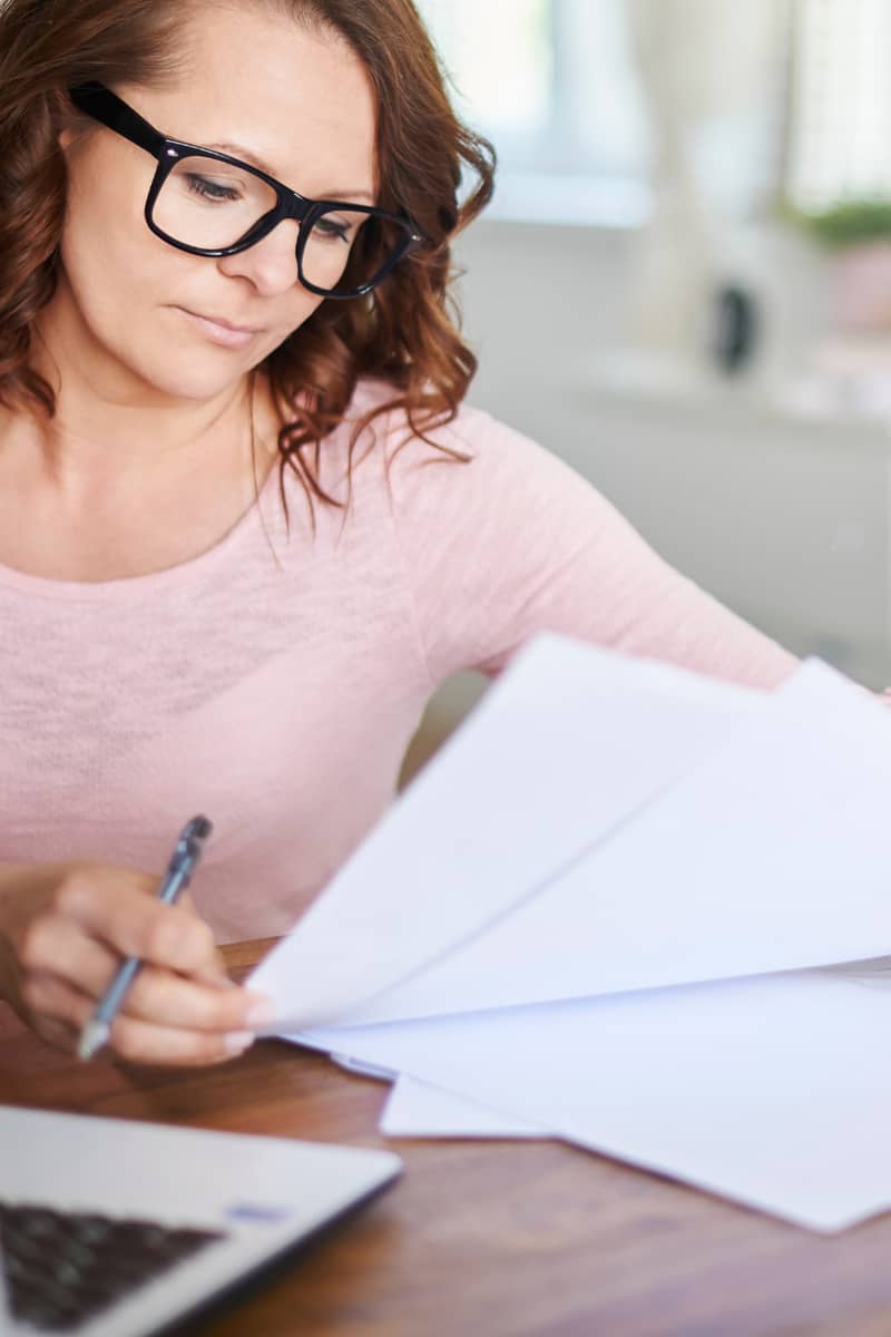 a lady sitting looking at her finances