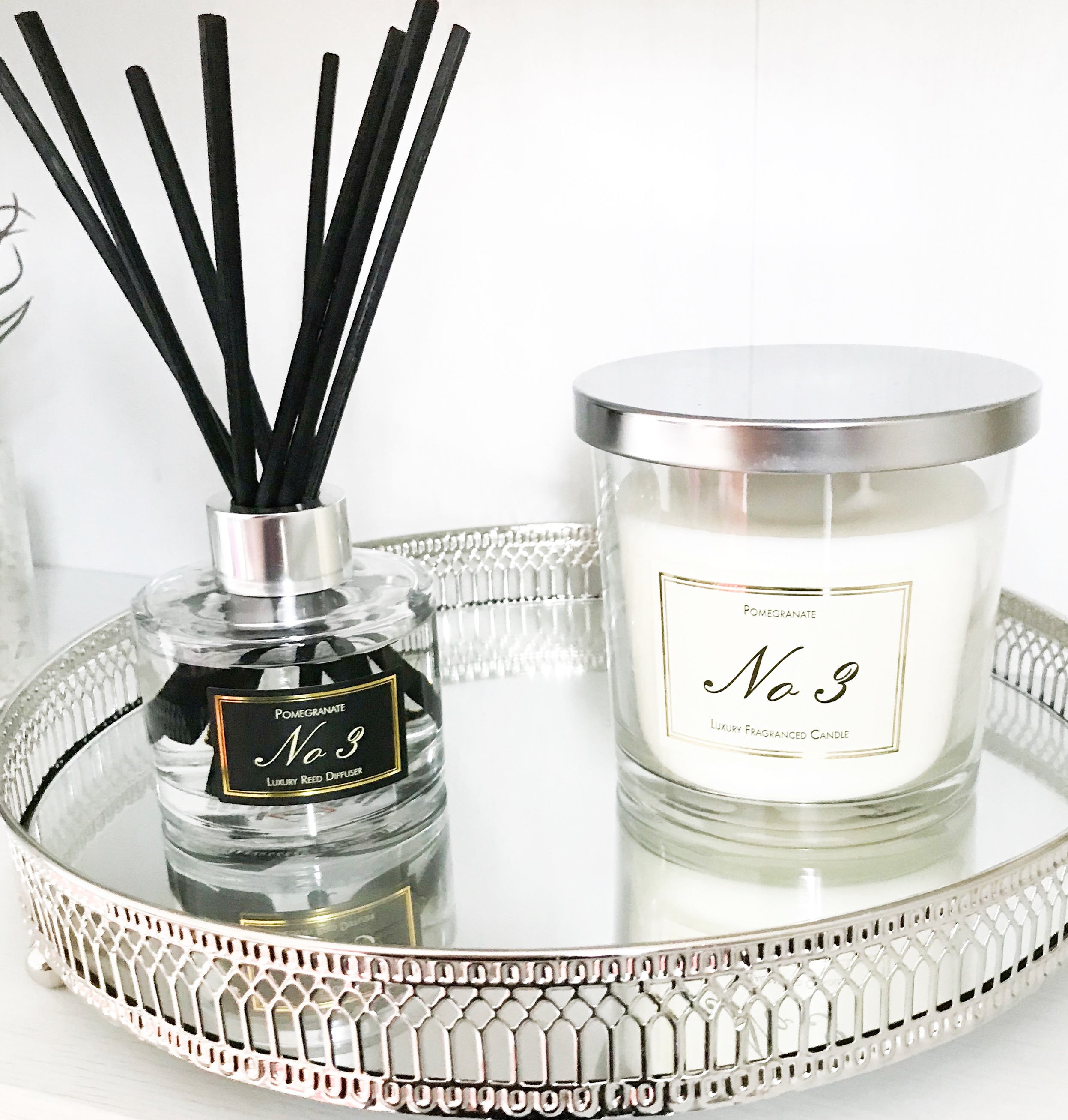 Aldi Candle and Diffuser sitting on a silver mirrored tray crating a cosy scene