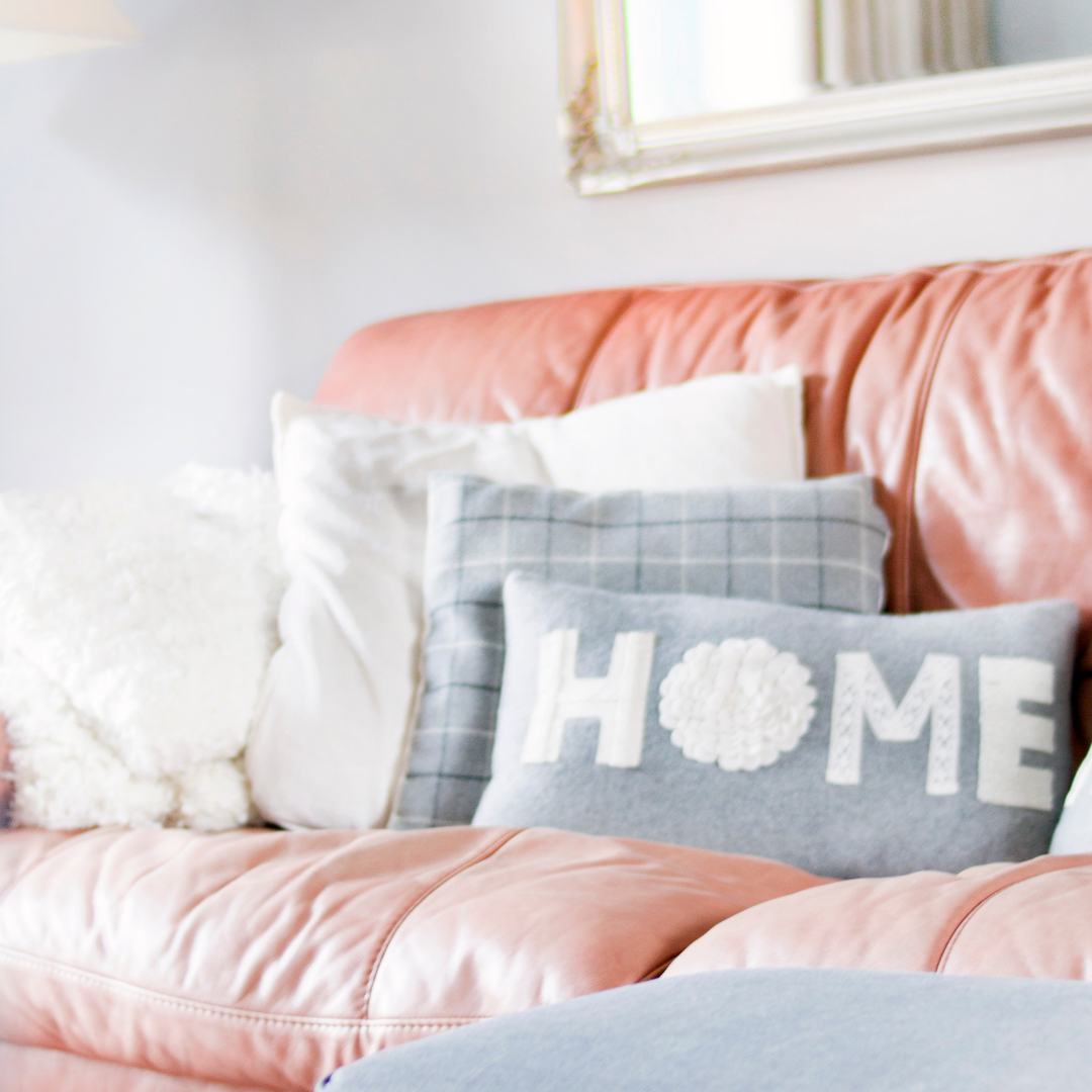 a sofa in a home with cushions on