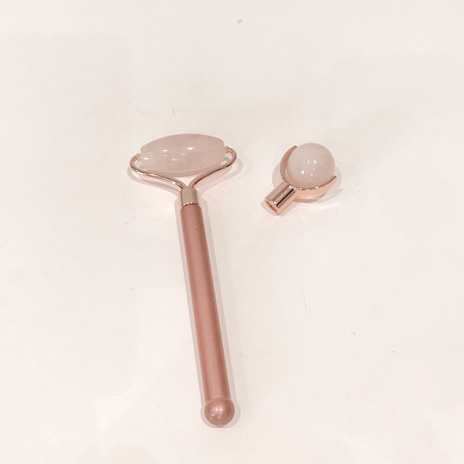a pink quartz roller with an inter-changable head