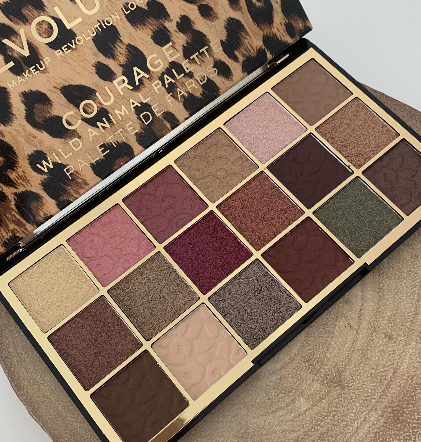 an eyeshadow palette opened up showing the colours