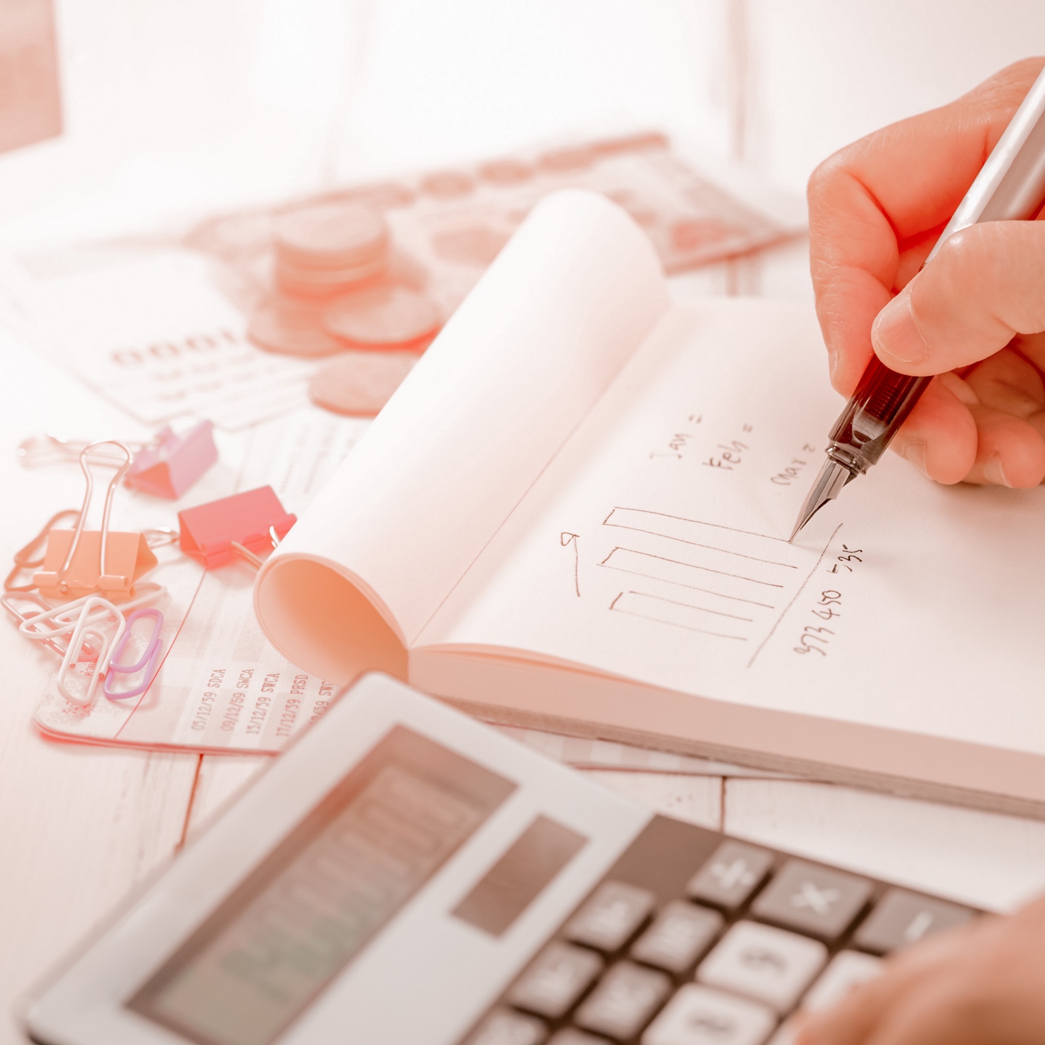 a calculator with a notepad being written in