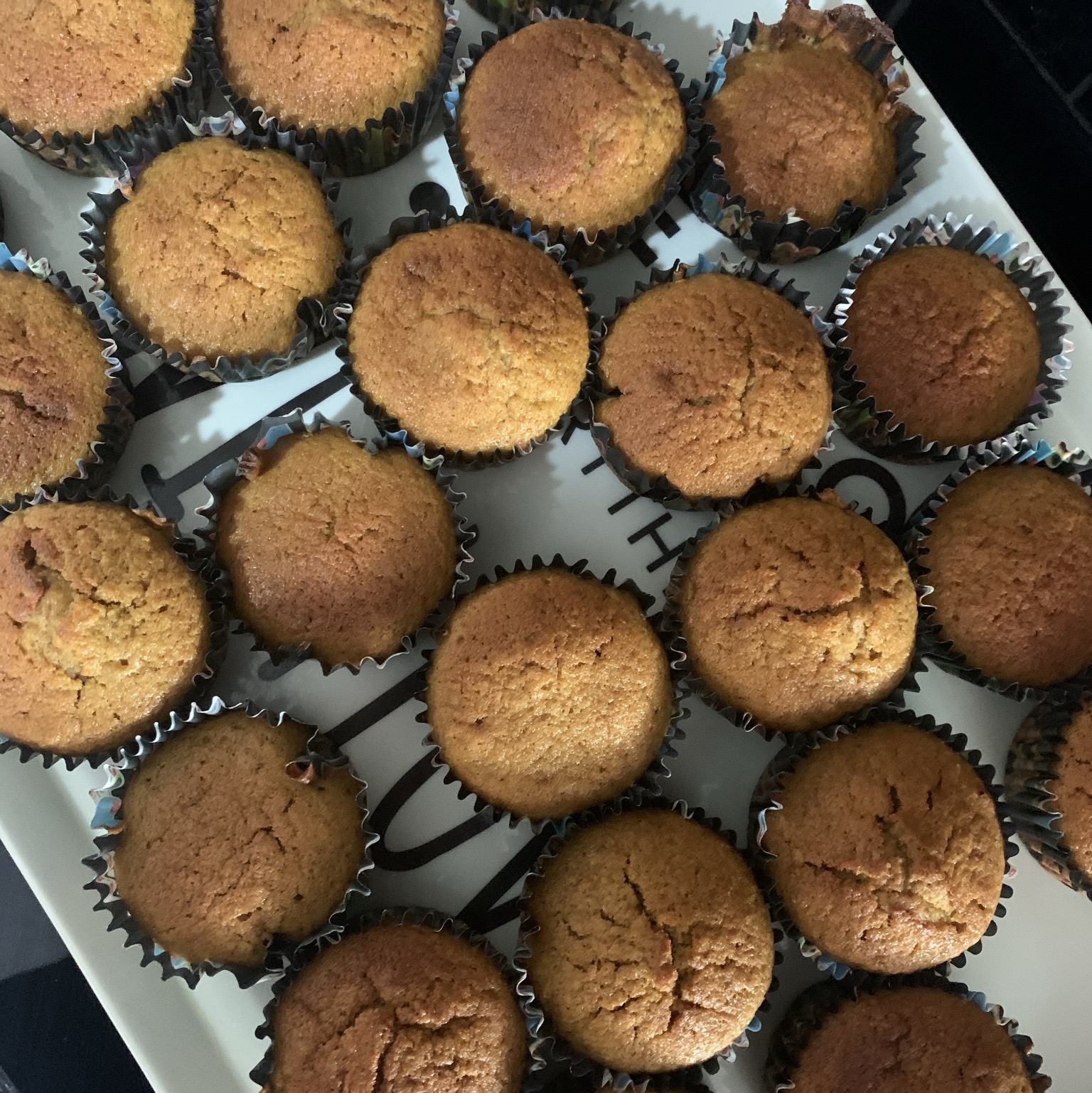 a tray of pumpkin cupcakes cooling