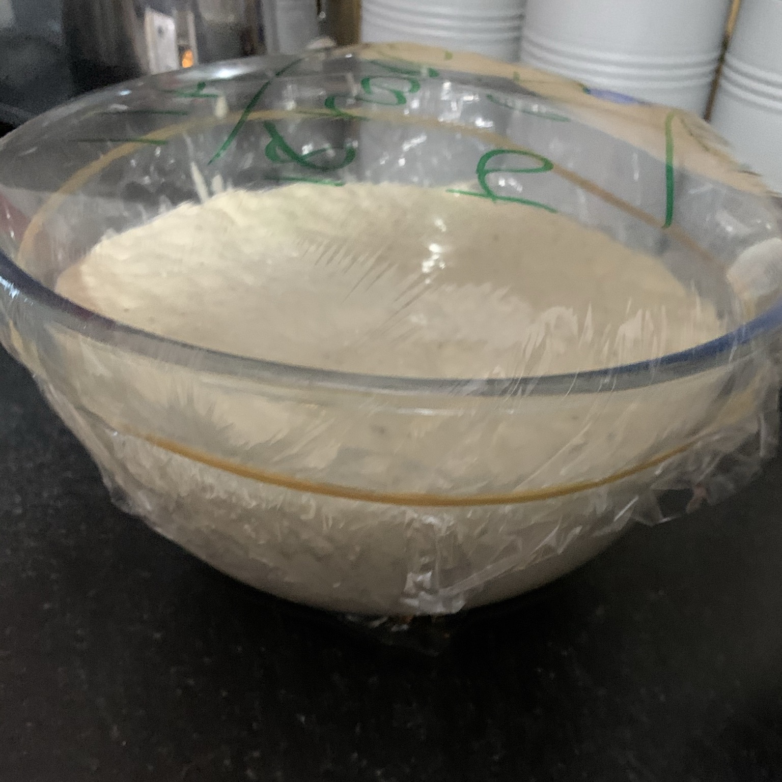 the dough rising in a bowl showing how to make bread
