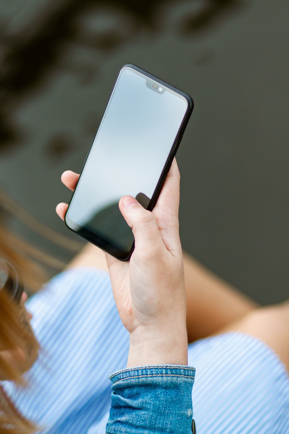 a hand holding a mobile smart phone