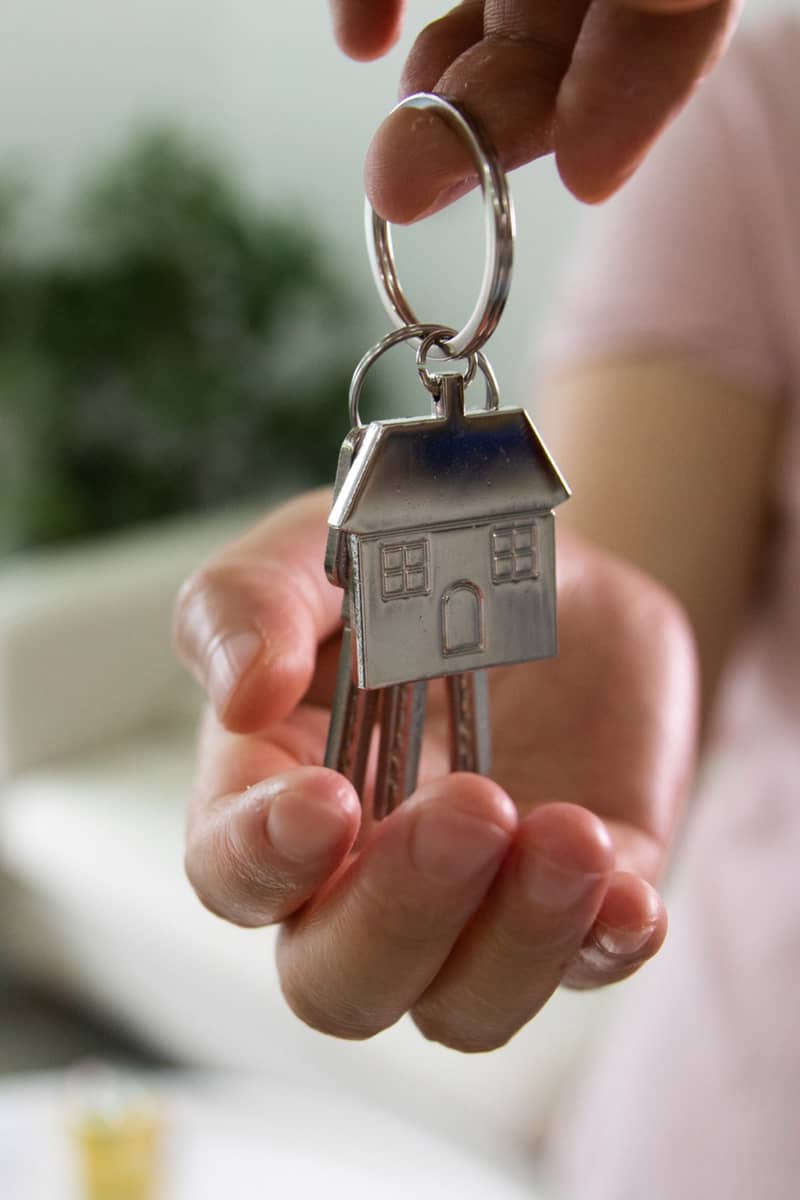 a hand being held open with a new homeowner set of keys