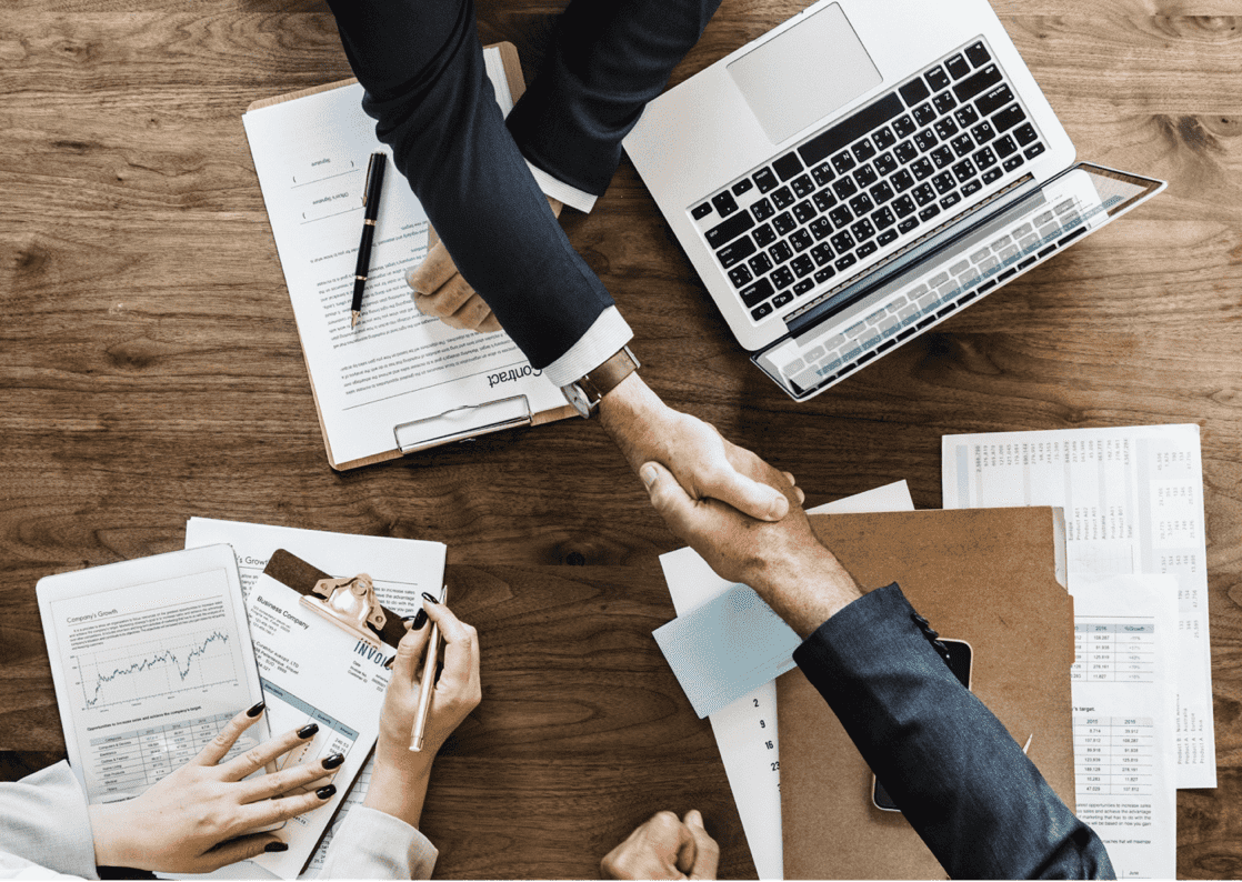 a group of people shaking hands after a Successful Business Tips meeting