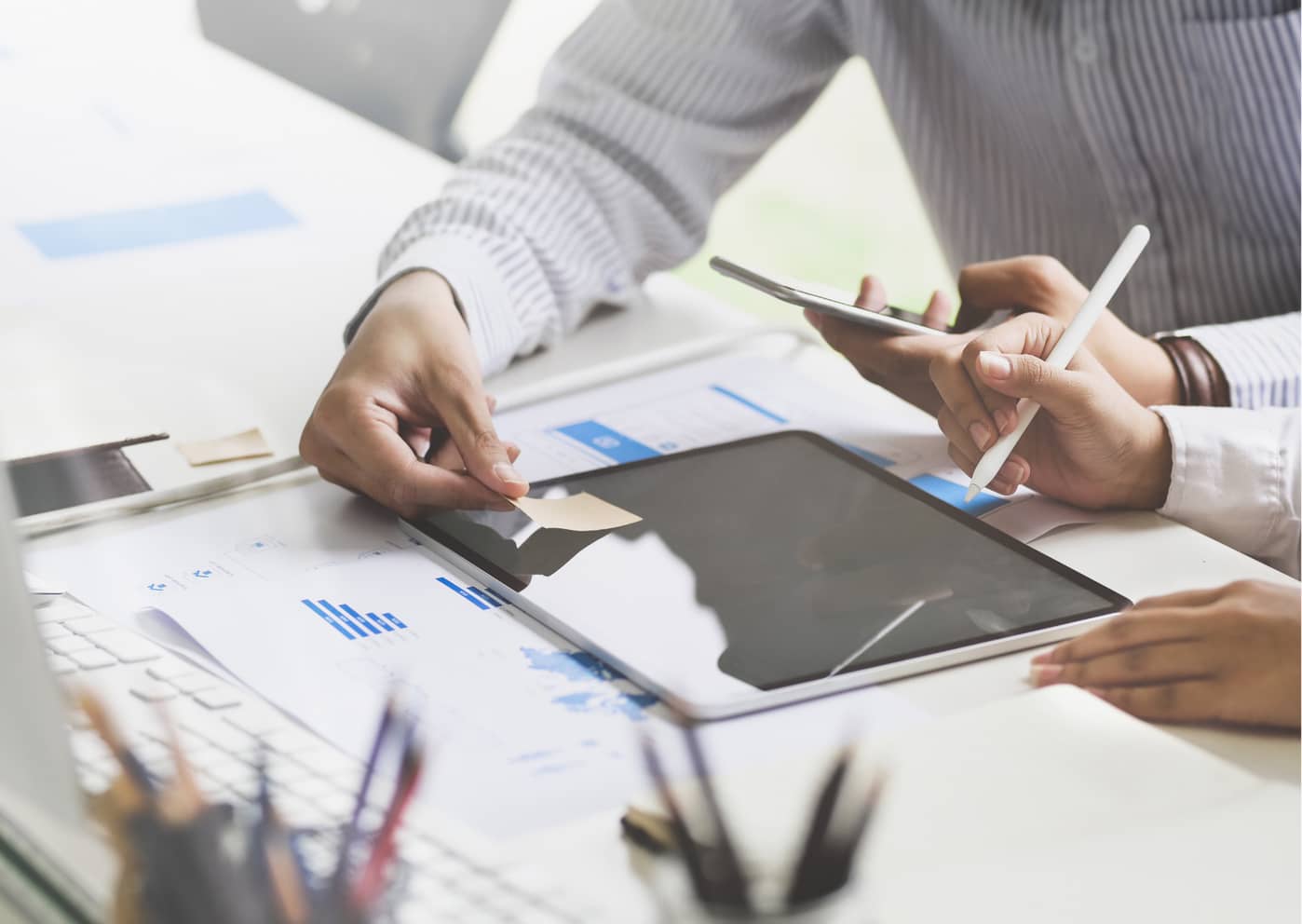 a person sitting at a desk with a laptop planning their next business idea