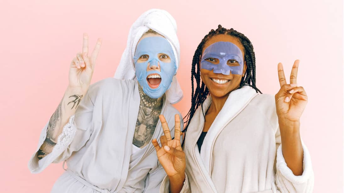 2 ladies wearing skincare facemasks and looking happy