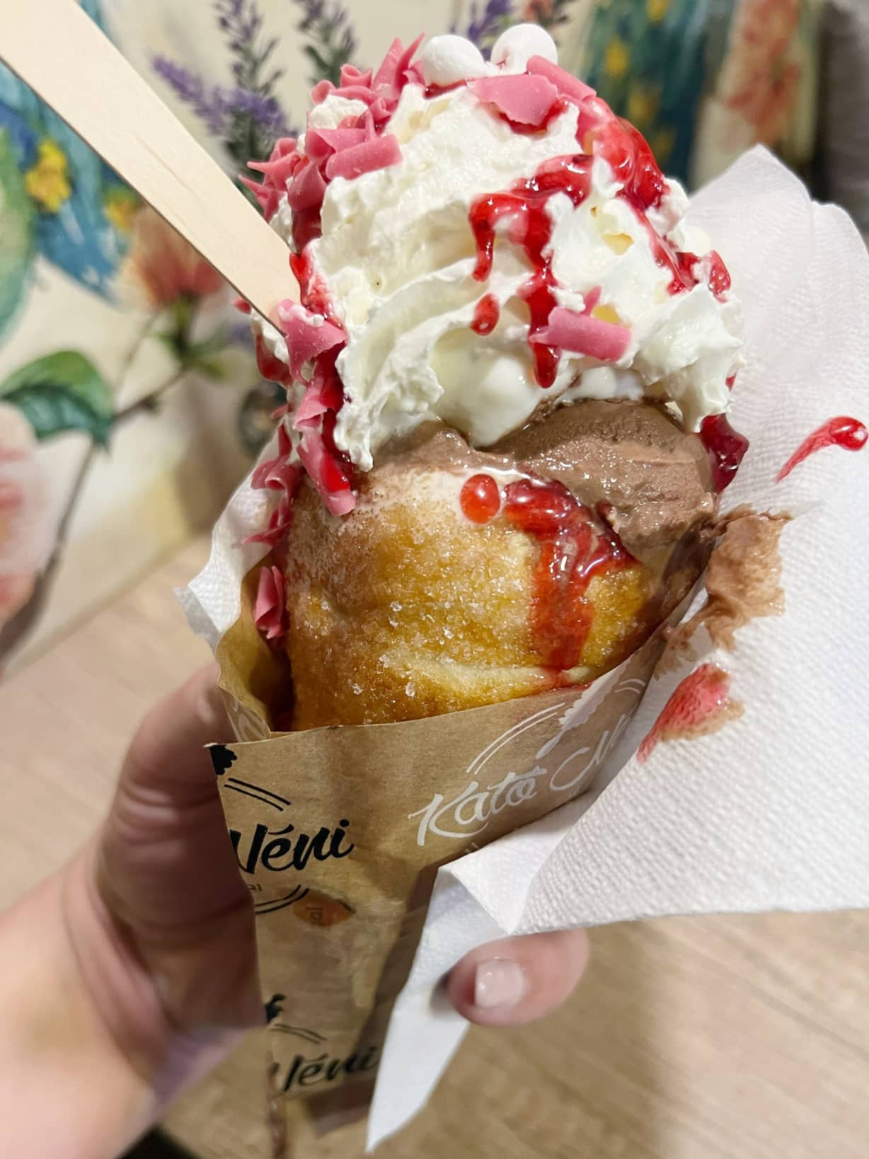a close up of an ice-cream filled chimney cake cone in Budapest