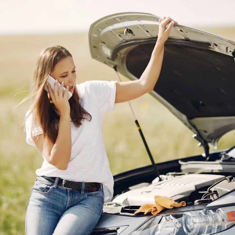 A lady with her car bonnet open