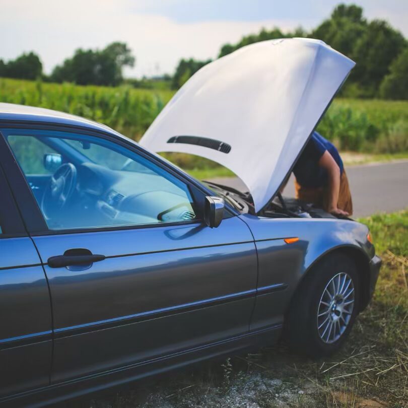 A broken down car with the bonnet open