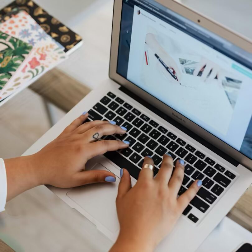 hands typing on a laptop