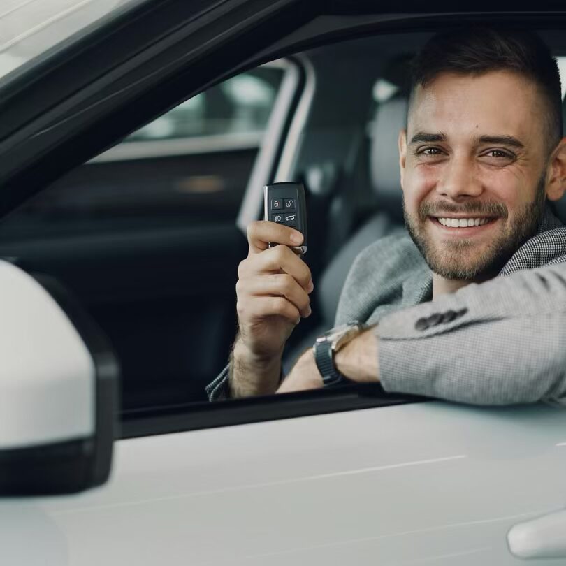 man looking out a car window